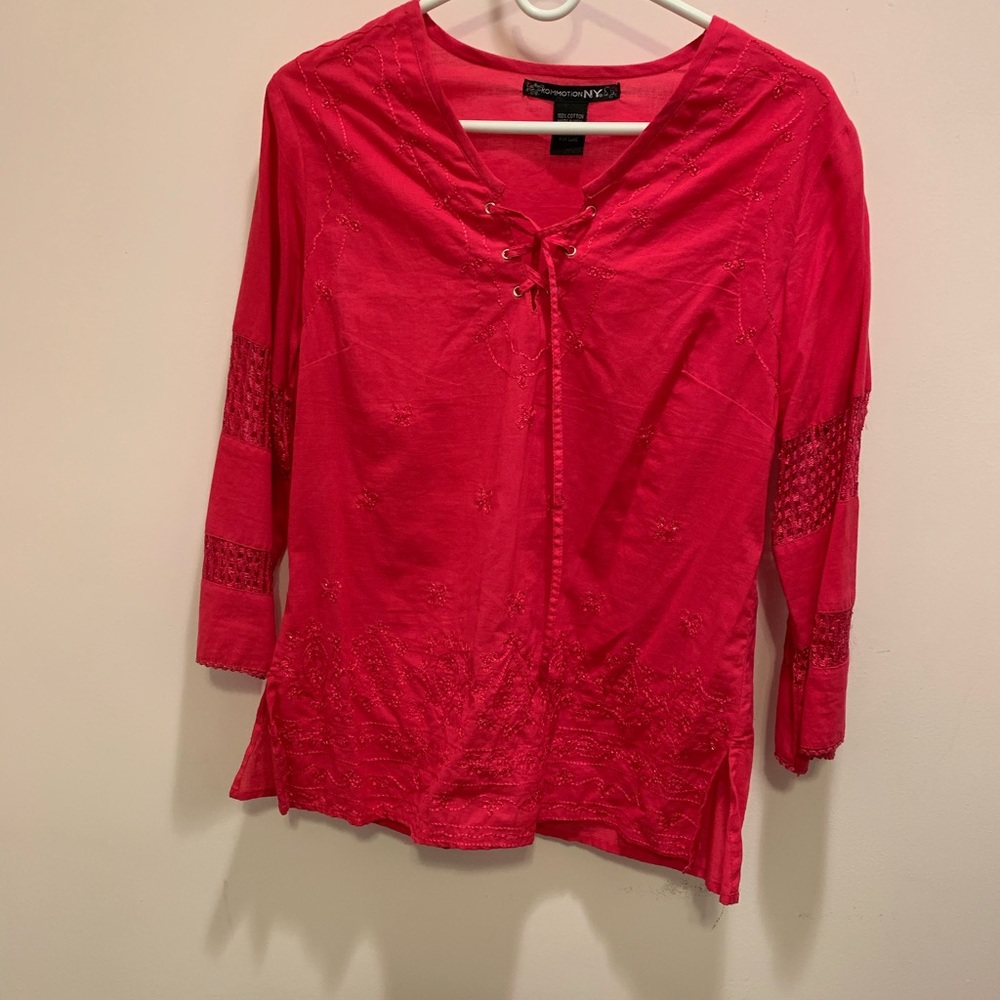 Pink shirt (comes off more as red on camera)